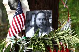 Photos of Samuel DuBose hang on a pole at a memorial, Wednesday July 29, 2015 in Cincinnati, near where he was shot and killed by a University of Cincinnati police office. Murder and manslaughter charges were announced against University of Cincinnati Police Officer Ray Tensing for the traffic stop shooting death of DuBose. (AP Photo/Tom Uhlman)